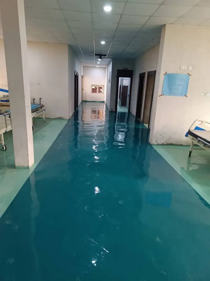 Teal glossy epoxy floor in a hospital corridor in Awka