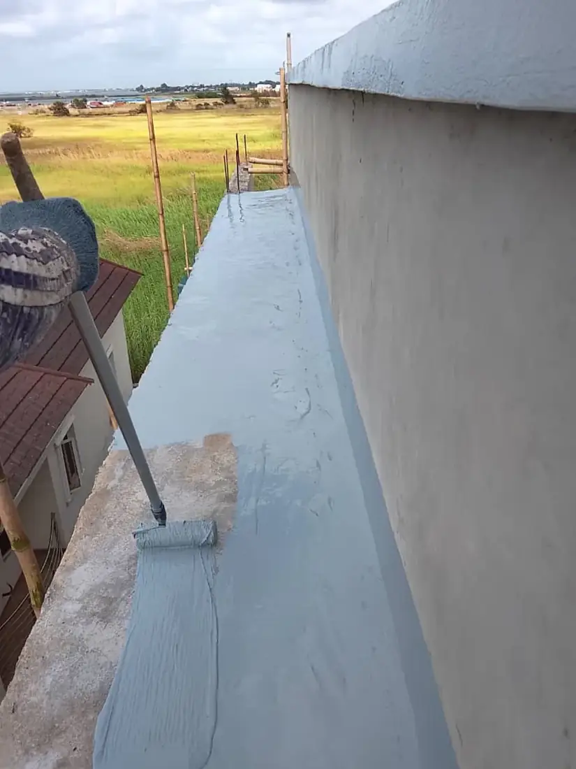 Polyurethane coating rolled onto an Ibadan terrace parapet