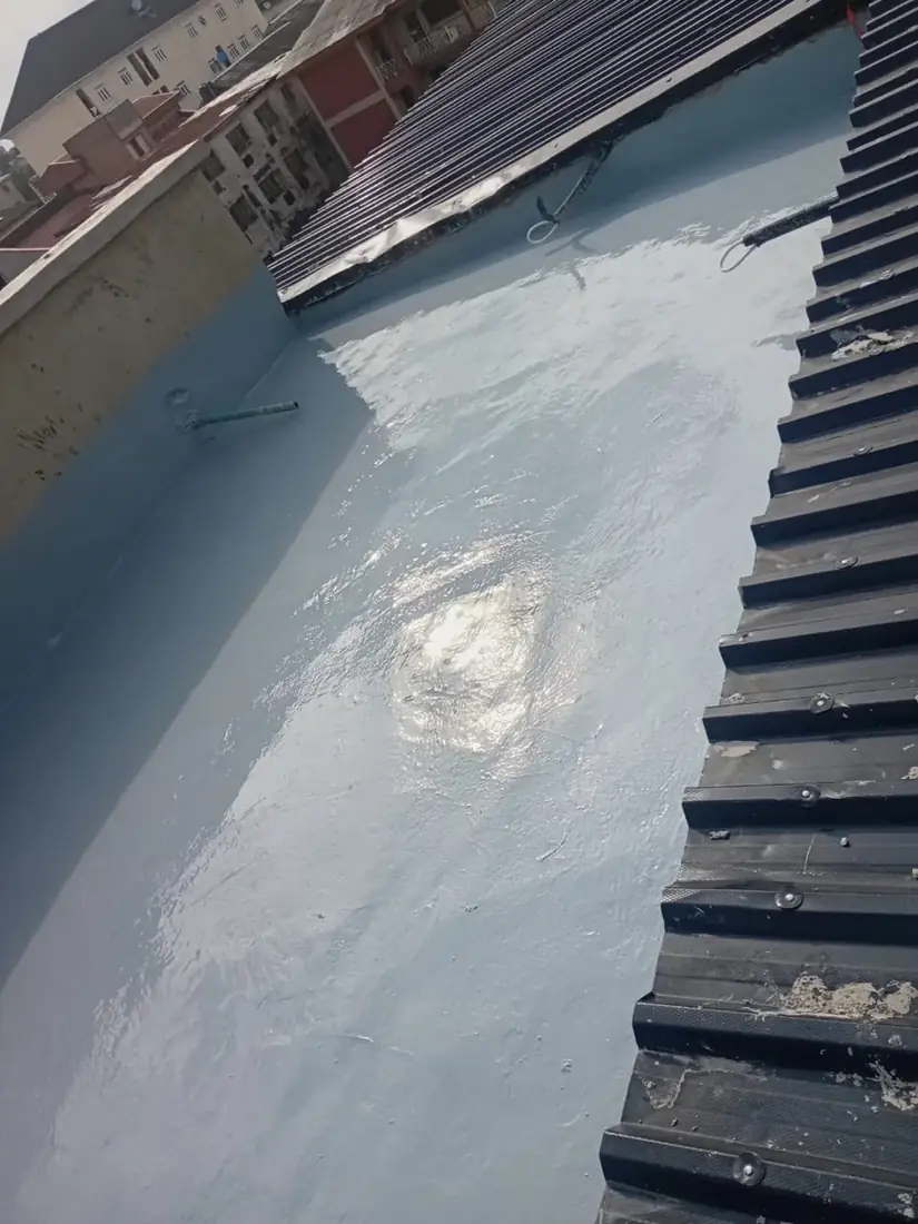 Completed light-blue polyurethane roof waterproofing in Ibadan